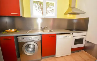 a kitchen with a washing machine and a sink at Cozy Home In Cabannes With Wifi in Cabannes