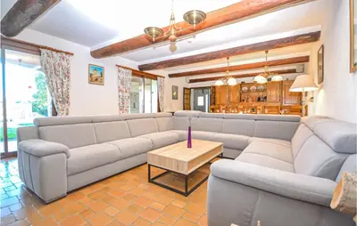 a living room with a couch and a table at Cozy Home In Aubignan in Aubignan