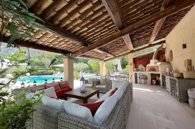 a patio with a couch and a table and a pool at Villa de 300 m au coeur du Luberon au calme sans in Maubec