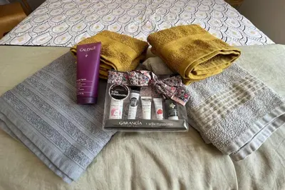 a pile of towels and a book on a bed at Villa de 300 m au coeur du Luberon au calme sans in Maubec