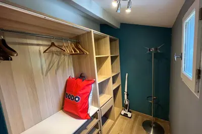 a walkin closet with a red bag sitting on a counter at Gite Studio indépendant au cœur du Luberon in Maubec