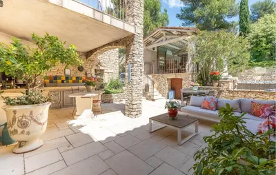 an outdoor patio with a couch and a table at Amazing Home In Orgon in Orgon