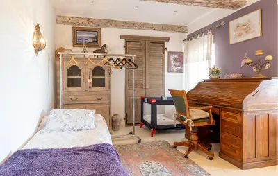 a bedroom with a bed and a desk and a piano at Amazing Home In Orgon in Orgon