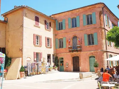 a group of buildings with people sitting in front of them at nid2nuit Nuance d'Ocres in Apt