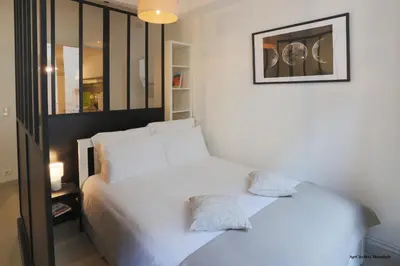 a bedroom with two white beds and a picture on the wall at AptCityStay in Apt