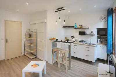 a kitchen with white cabinets and a counter top at AptCityStay in Apt