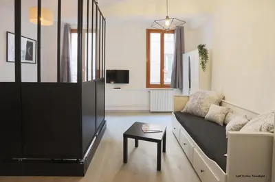 a living room with a couch and a table at AptCityStay in Apt