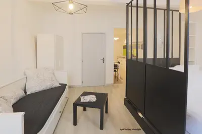 a living room with a couch and a table at AptCityStay in Apt