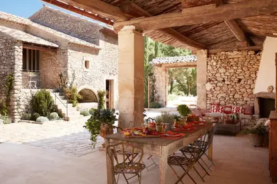 a patio with a table with food on it at Le Mas Vermentino, La Bastide de Marie, Villa avec services in Ménerbes