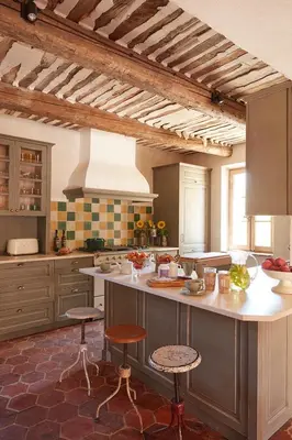 a kitchen with a large island with two stools at Le Mas Vermentino, La Bastide de Marie, Villa avec services in Ménerbes
