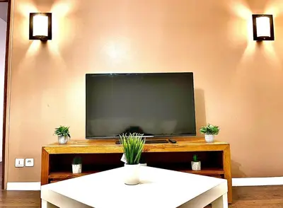 a flat screen tv sitting on top of a table at *FONTAINE MOUSSUE*HYPER CENTRE*T2 STANDING* in Salon-de-Provence