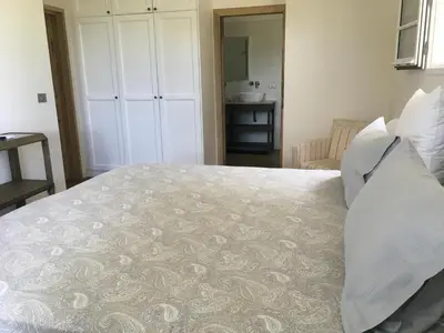 a bedroom with a large bed with white pillows at La Soleillade Aixoise in Aix-en-Provence
