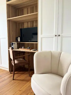a living room with a couch and a desk with a television at La Soleillade Aixoise in Aix-en-Provence