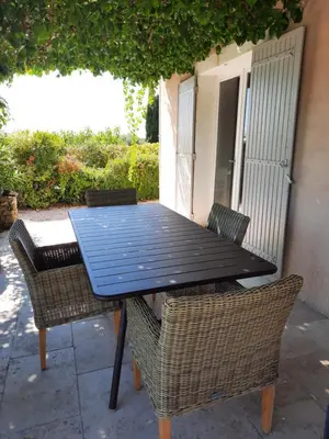 a black table and chairs on a patio at Villa Les Oliviers in Caromb