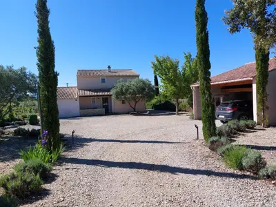 a driveway in front of a house with trees at Villa Les Oliviers in Caromb