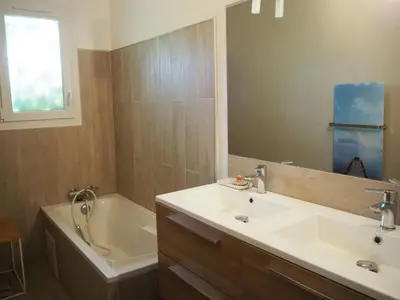 a bathroom with a sink and a tub and a mirror at Holiday Home in Pertuis with Private Pool in Pertuis