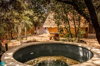 a circular pool in a yard with a tree at Sortilège in Lambesc