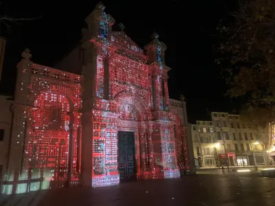 a building is lit up with red and white lights at Le Petit Marius in Aix-en-Provence