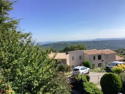 a kitchen with white cabinets and a red microwave at Numéro 190 rue des moulins Nid douillet au cœur de la haute Provence vachéres in Reillanne