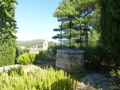 a large barrel in the middle of a garden at Le Clos des Merveilles in Rognes