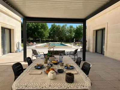 a table with food on it on a patio at Domaine des Eucalyptus in Mollégès