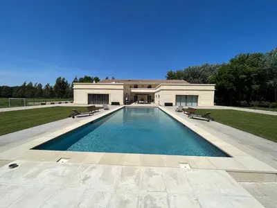 a large swimming pool in front of a house at Domaine des Eucalyptus in Mollégès