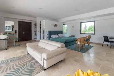 a living room with a couch and a bed at Domaine des Eucalyptus in Mollégès