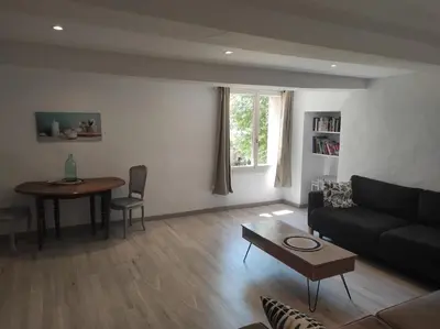 a living room with a couch and a table at Entre blé et lavande in Bonnieux