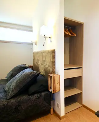 a bedroom with a bed and a book shelf at Le Jardin d'Érables St Remy 7 HA Piscine/Clim in Paluds de Noves