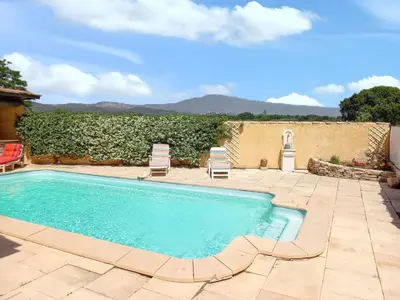 a swimming pool with two lawn chairs in a yard at Maison avec piscine privée à Caromb, idéale pour famille in Caromb