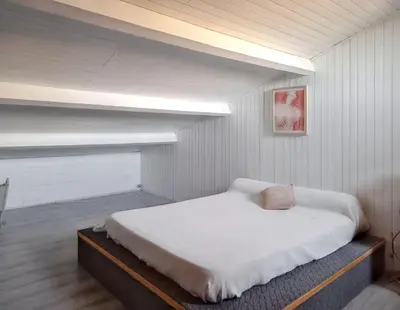 a small room with a bed in a attic at Maison avec piscine privée à Caromb, idéale pour famille in Caromb