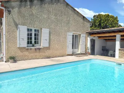 a swimming pool in front of a house at Maison avec piscine privée à Caromb, idéale pour famille in Caromb