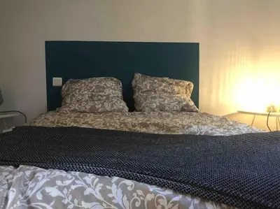 a bed with two pillows on top of it at Belle maison provençale au pied du Mont Ventoux in Caromb