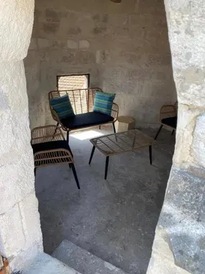 a group of chairs and a table in a room at La tour 2: Appart neuf au cœur de la petite venise in LʼIsle-sur-la-Sorgue