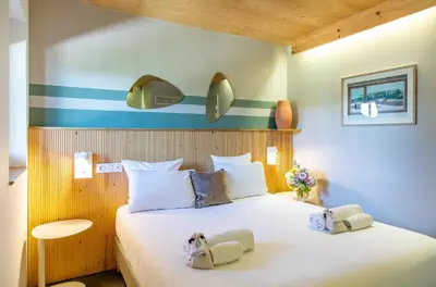 a bedroom with a bed with two towels on it at thecamp hôtel - Aix en Provence in Aix-en-Provence