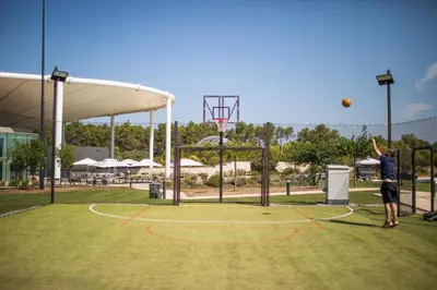 a man is playing basketball on a basketball hoop at thecamp hôtel - Aix en Provence in Aix-en-Provence