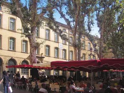 a group of people sitting at tables in front of a building at Cozy Vacation House with Pool, Vernègues in Vernègues