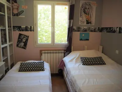 two beds in a room with a window at Cozy Vacation House with Pool, Vernègues in Vernègues
