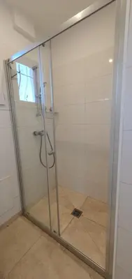 a shower with a glass door in a bathroom at Maison calme et rénovée 