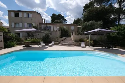 a large blue swimming pool next to a building at villa with pool and beautiful view in the luberon in pujet sur durance - 10 in Puget