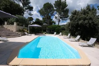 a swimming pool with chaise lounge chairs and a swimming pool at villa with pool and beautiful view in the luberon in pujet sur durance - 10 in Puget
