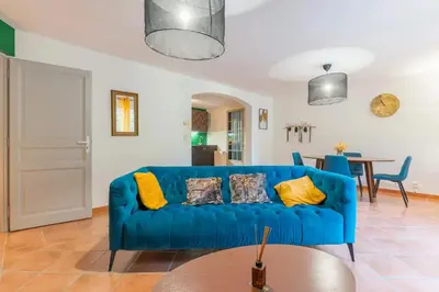 a blue couch in a living room with a table at Domaine Plan des Devens in Roussillon