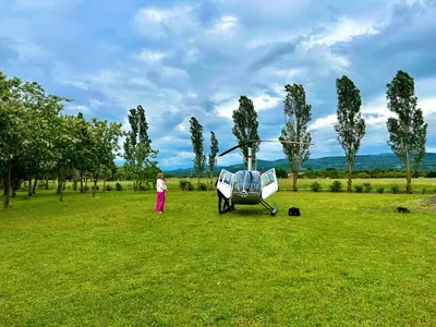 a person standing next to a helicopter in a field at Domaine Plan des Devens in Roussillon