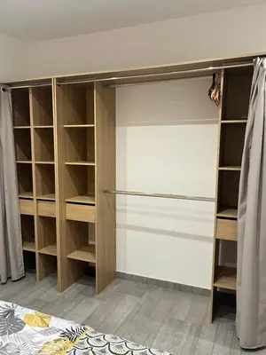 a walk in closet with wooden shelves and cabinets at Logement privé à proximité du Mont Ventoux in Carpentras