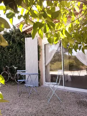 two chairs and a table in front of a window at Bastide Cedrea in Peyrolles-en-Provence
