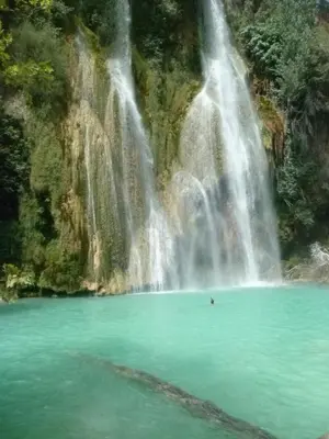 a waterfall in front of a body of water at Bastide Cedrea in Peyrolles-en-Provence
