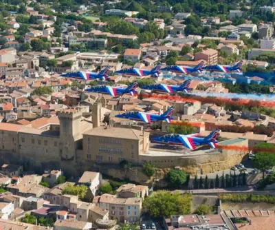 a bunch of flags flying over a city at Woods Natural Hyper centre Fontaine Moussue in Salon-de-Provence