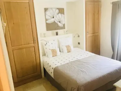 a bedroom with a bed with a white flower on the wall at MAS DE CHARME EN PROVENCE in Le Thor