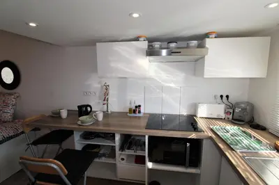 a kitchen with white cabinets and a counter top at Les Bastidons de L'Isle - st ju- 3 étoiles in LʼIsle-sur-la-Sorgue
