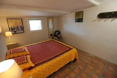 a bedroom with a bed and a window at LUBERON DES ARTISTES 2 in Apt